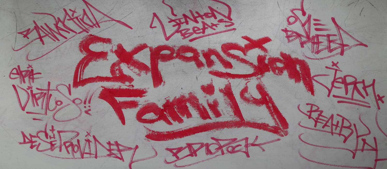 Graffiti wall tagged Expansion Family by every member in red marker